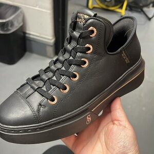 Stylish Black Sneakers with Copper Accents